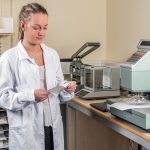 A person wearing a lab coat in a lab